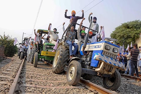 Farmers raise slogans as they block train tracks with tractors on the twentieth day of their ongoing 'Rail Roko' protest. (File photo| PTI)