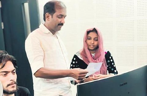 Subair Pandallur explaining a song to a singer at his studio | Express