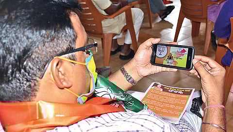 A BJP leader attending Home Minister Amit Shah’s  virtual rally at a BJP party office. (Photo | EPS)
