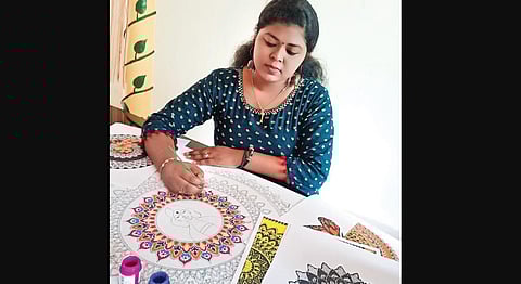 Athira Sasi working on a painting | Express