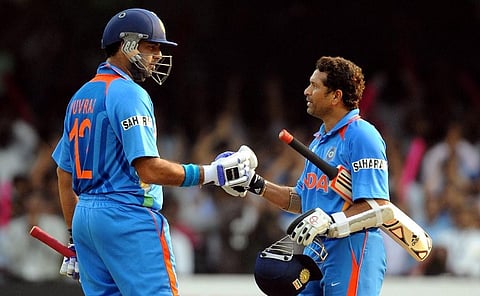 Yuvraj Singh (L) congratulates teammate Sachin Tendulkar. (Photo | AFP)