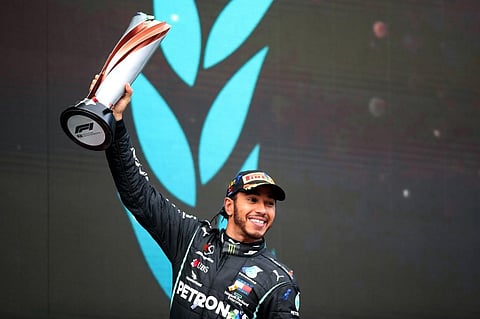 Winner Mercedes' British driver Lewis Hamilton celebrates on the podium after the Turkish Formula One Grand Prix. (Photo | AFP)