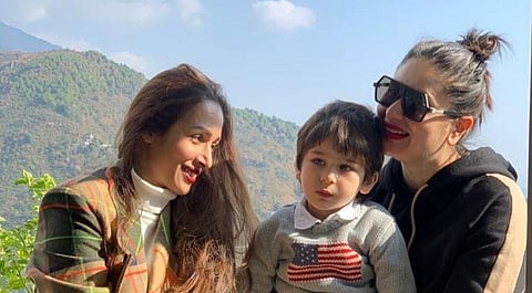 In the adorable picture, which is from a book cafe, Kareena is seen holding Taimur close as they all smiled for the camera.
