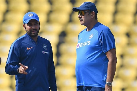 Rohit Sharma (L) speaks with coach Ravi Shastri during a training session. (Photo | AFP)