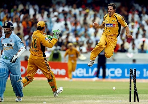 Australian cricketer Brad Hogg (R) jumps in air to celebrate alongwith teammate Adam Gilchrist (C) the wicket of Indian cricketer Sachin Tendulkar (L). (Photo | AFP)