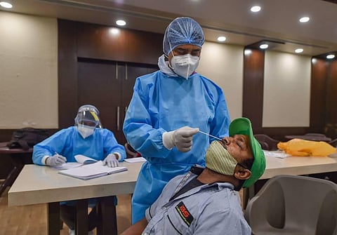 A health worker collects samples from a Delhi District Cricket Association DDCA employee for COVID-19 test in New Delhi Monday Nov.2 2020. (Photo | PTI)