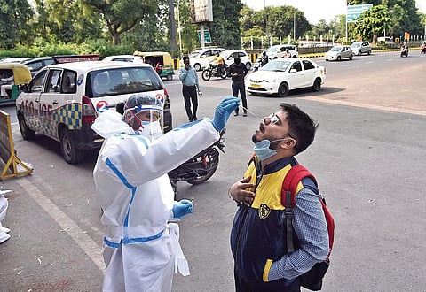 A communter undergoes Covid test in Noida on Wednesday. People arriving from Delhi are being randomly tested. (Photo | Parveen Negi, EPS)