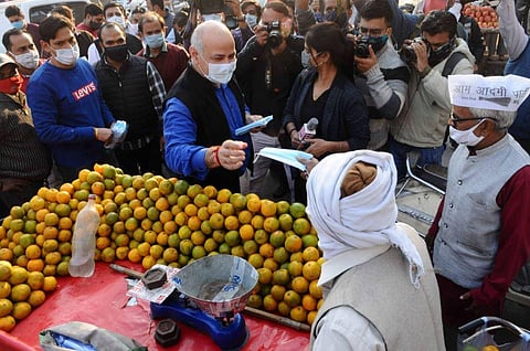 Deputy Chief Minister Manish Sisodia distributes free masks among people at Vinod Nagar Market in East Delhi. (Photo | PTI)