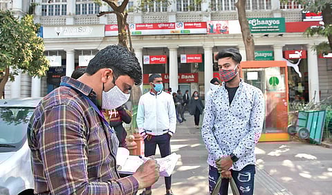 A civil defence personnel challans a man found not wearing a mask in New Delhi on Saturday | SHEKHAR YADAV