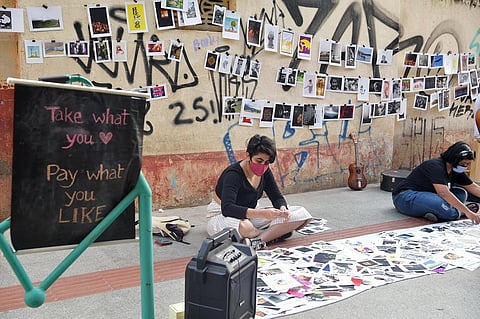 Passers-by spend hours selecting their favourites from the postcards on display. (Photo | Meghana Sastry, EPS)
