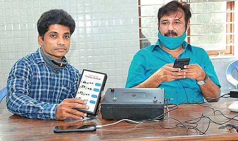 Rishikesh explaining the functioning of his electronic voting device to Alappuzha MP, A M Ariff,  at Muhamma | Express