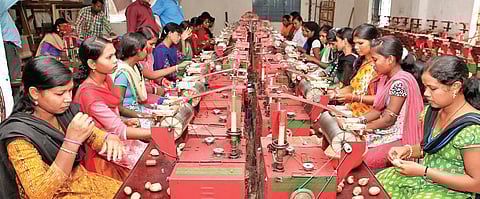 Women spinning silk thread at the Tasar Silk Park in Keonjhar. (Photo | EPS)