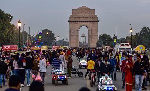 People visit the India Gate at Rajpath, amid the ongoing coronavirus pandemic, in New Delhi. (Photo | PTI)