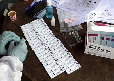 A health worker prepares kits to test for COVID-19 on a street in Mumbai, India, Tuesday, Nov. 24, 2020. (Photo | AP)