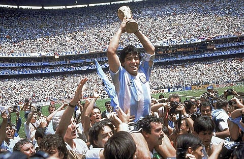 Diego Maradona holds up his team's trophy after Argentina's 3-2 victory over West Germany at the World Cup final match. (Photo | AP)