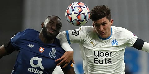 FC Porto's Moussa Marega (L) and Olympique Marseille's Leonardo Balerdi challenge a ball during the Champions League group C soccer match at the Velodrome stadium. (Photo | AP)