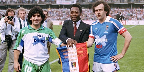 Soccer stars Argentina's Diego Maradona, left, Pele of Brazil, center, and France's Michel Platini pose shaking hands during Platini's jubilee at Nancy stadium. (File Photo | AP)