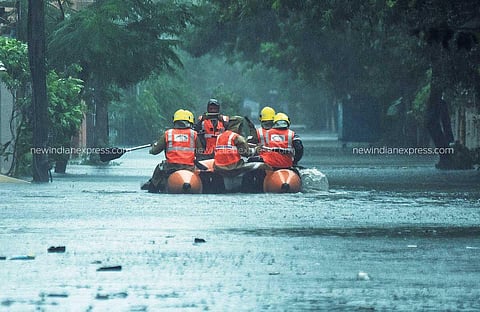 Fire officials rescue people affected by the flood due to incessant rains at Velachery in Chennai. (Photo | Ashwin Prasath, EPS)