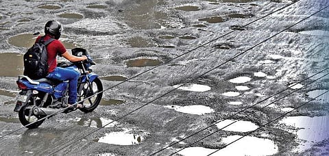 A man rides on RC road, which was severely damaged by the rain in Tirupati on Wednesday | Madhav K