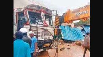 A crane moves the container truck, which went out of control and caused an accident in Chikkaballapur on Thursday. 
