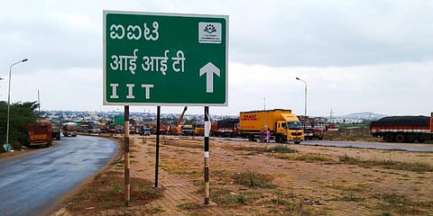IIT signboard at Gabbur shows the way to the IIT temporary campus which is located near High Court of Karnataka Dharwad bench. (Photo | EPS)