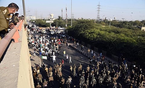 Bharatiya Kisan Union members attempt to cross a police barricade at Ghazipur border during their Delhi Chalo march. (Photo | Parveen Negi/EPS)