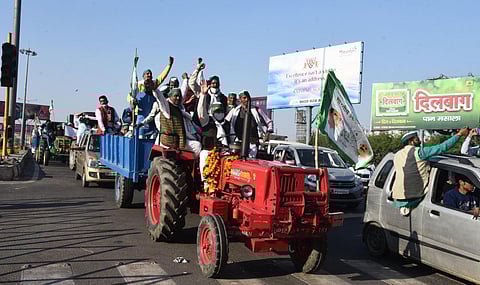 Bharatiya Kisan Union BKU members raise slogans as they ride on tractors at Ghazipur border during their Delhi Chalo protest march against the new farm laws in New Delhi. (Photo | Parveen Negi, EPS)