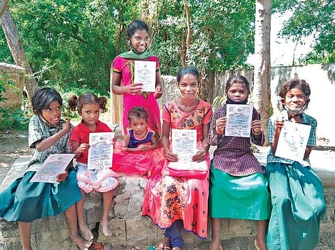 Sub-Collector S Anu on Monday distributed the certificates to tribals residing at Jakkampettai in Tindivanam | Express