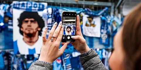 Napoli beat Roma 4-0 in an emotional match in the Italian league on Sunday as the team paid tribute to Diego Maradona. It was Napoli's first Serie A game since Maradona died on Wednesday in his native Argentina. IN PIC: A fan takes pictures of the memorab