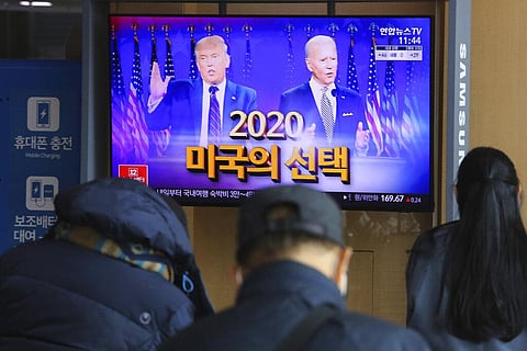 A TV screen shows images of U.S. President Donald Trump, left, and Democratic presidential candidate former Vice President Joe Biden during a news program at the Seoul Railway Station in Seoul| AP