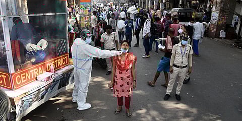 A health worker collects a swab sample from a woman for coronavirus testing at Sadar Bazaar in New Delhi. (Photo| Parveen Negi, EPS)