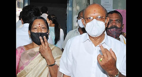 T B Jayachandra, Congress candidate for Sira, and his wife Nirmala  after casting their votes, on Tuesday | Express