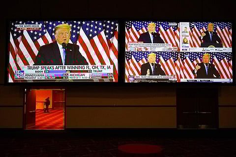 A live broadcast of President Donald Trump speaking from the White House is shown on screens at an election night party in Las Vegas. (Photo | AP)