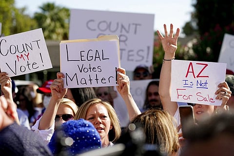 Protesters hold signs during an Arizona Republican Party news conference, Thursday, Nov. 5, 2020, in Phoenix. (Photo | AP)