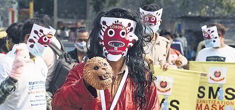 Volunteers wearing masks participate in a Covid-19 awareness campaign in Central Delhi on Friday. (Photo | Parveen Negi, EPS)