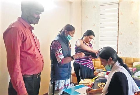 ACB officials examine documents in the house of B Sudha (above) in Bengaluru