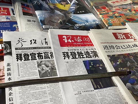 Newspaper front-page with the headlines 'Biden wins' are displayed at newsstand in Beijing, China. (Photo | AP)