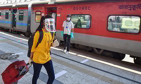 A passenger walks to board a train to Delhi at Howrah Station following resumption of passenger train services connecting major cities during the ongoing COVID-19 nationwide lockdown in Kolkata Tuesda