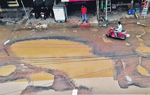 Deep potholes in the Oil Mill Road at Ayyappanthangal | Express