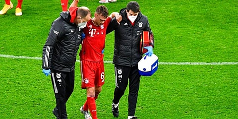 Bayern's Joshua Kimmich walks off after receiving medical treatment during German Bundesliga match against Borussia Dortmund. (Photo  AP)