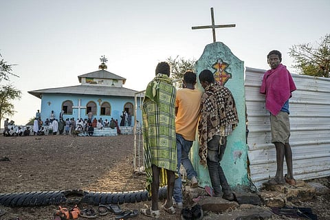 Tigrayan men who fled the conflict in Ethiopia's Tigray region, listen to a priest deliver a sermon during Sunday Mass, at a church near Umm Rakouba refugee camp in Qadarif, eastern Sudan. (Photo |AP)