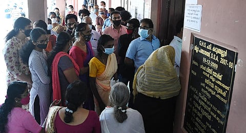 People waiting outside a polling station in Aluva on Thursday. (Photo | Albin Mathew, EPS)