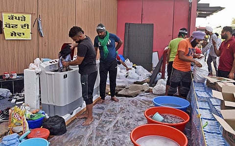 Farmers have started laundry service using multiple washing machines at Singhu border to help protesters. (Photo | Parveen Negi, EPS)