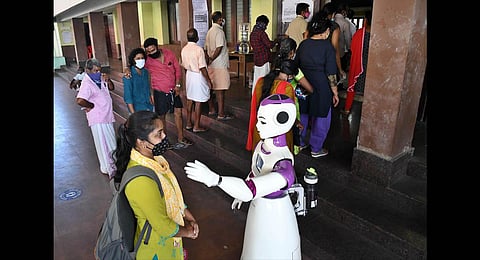 Robot Sayabot aiding voters at the polling booth in the community hall of Thrikkakkara Municipality. (Photo | Albin Mathew, EPS)