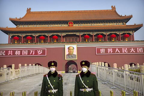 Paramilitary police wear face masks as they stand guard at Tiananmen Gate adjacent to Tiananmen Square in Beijing. (Photo | AP)