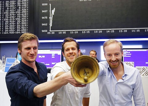 The three CEOs of Zalando, David Schneider, Robert Gentz and Rubin Ritter, from left, ring the bell during the company's initial public offering at the stock market in Frankfurt. (Photo | AP)