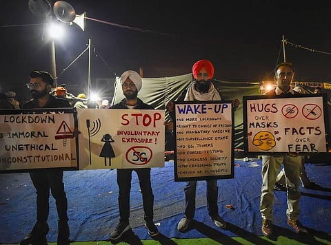 Farmers hold placards during their protest against the new farm laws at Singhu border in New Delhi Sunday Dec 13 2020. (Photo | PTI)