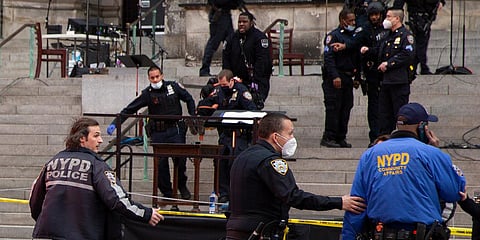 New York police officers carry a suspected gunman in a stretcher down the steps of Cathedral Church of St. John the Divine on Sunday. (Photo| AP)