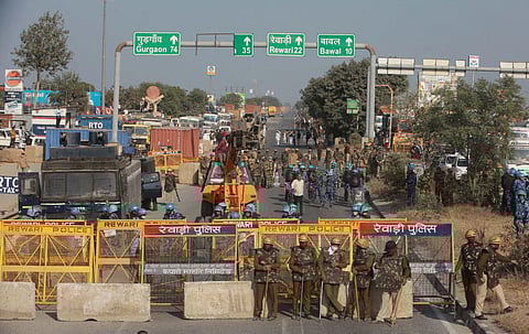 Police personnel stand along a highway on the Haryana-Rajasthan border to stop farmers from joining protests in Delhi. (Photo | Shekhar Yadav, EPS)