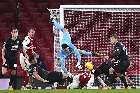 Burnley's goalkeeper Nick Pope dives over Arsenal's Gabriel during an English Premier League soccer match between Arsenal and Burnley at the Emirates stadium in London. (Photo | AP)